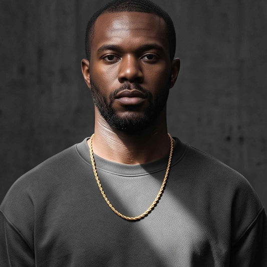 Medium shot of a male model wearing the iceX 5mm gold rope chain with a grey sweatshirt in an urban concrete setting.
