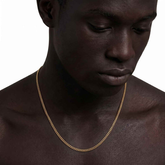 Studio close-up of a shirtless male model showcasing the iceX 5mm gold Miami Cuban chain on a plain white background.
