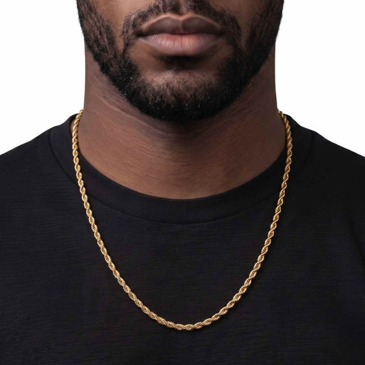 A close-up of a man wearing a 5mm thick, 18K PVD gold rope chain over a black t-shirt, against a plain white background.