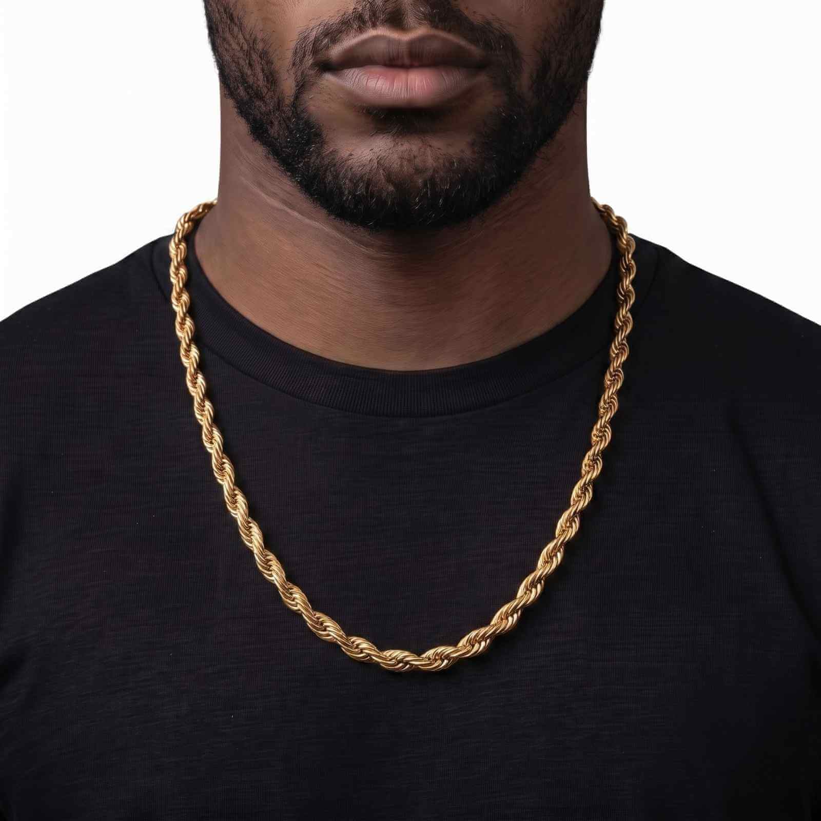 A close-up of a man wearing a thick, 18K PVD gold rope chain over a black t-shirt, against a plain white background.