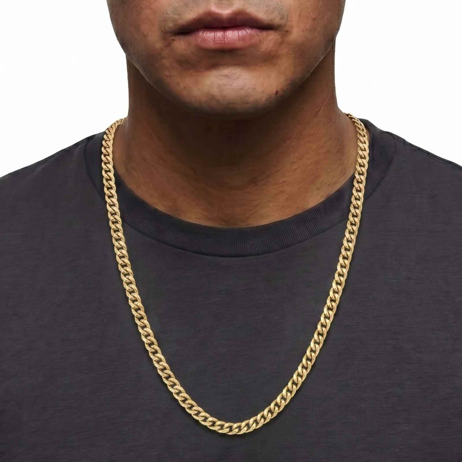 Close-up shot of a male model wearing the iceX 9mm gold Miami Cuban chain over a dark grey t-shirt.